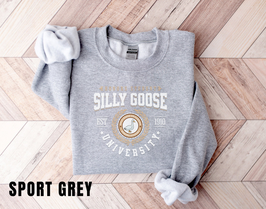 a grey sweatshirt with a white bow on it