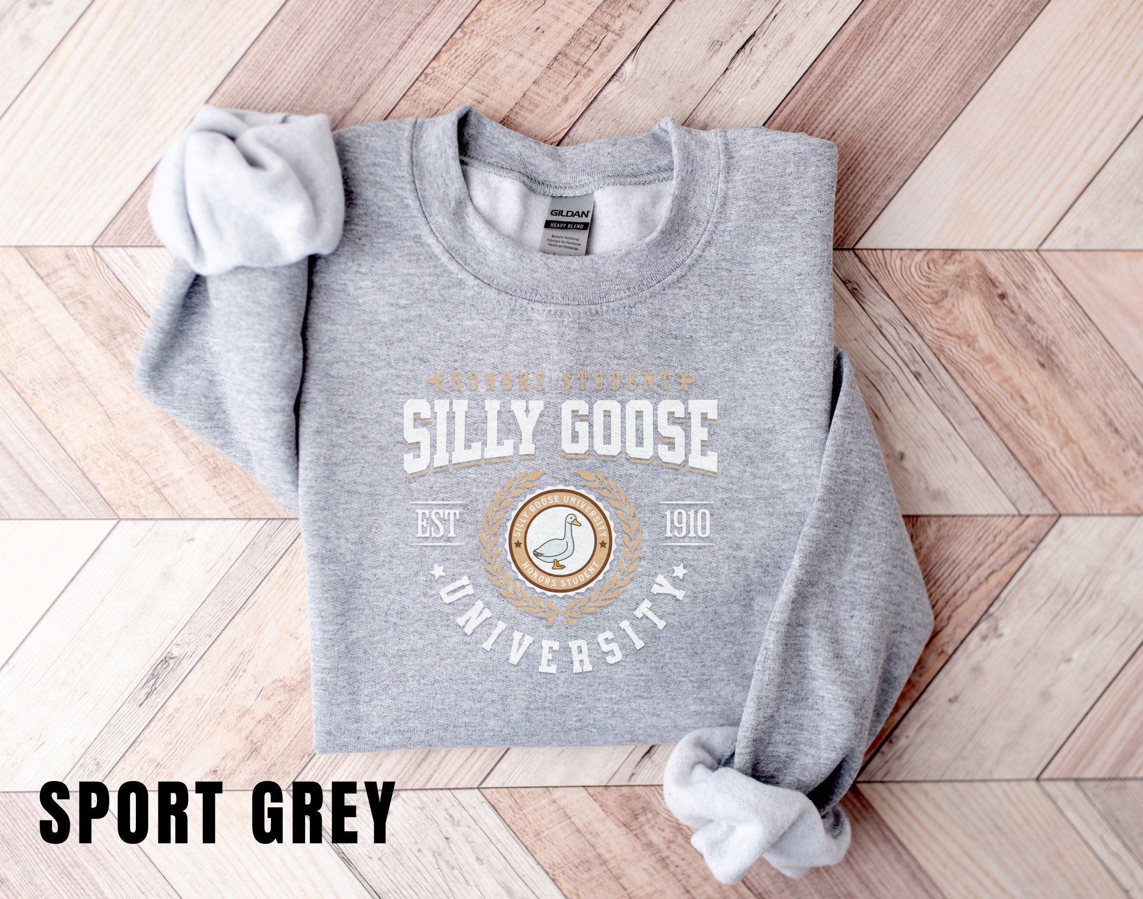 a grey sweatshirt with a white bow on it