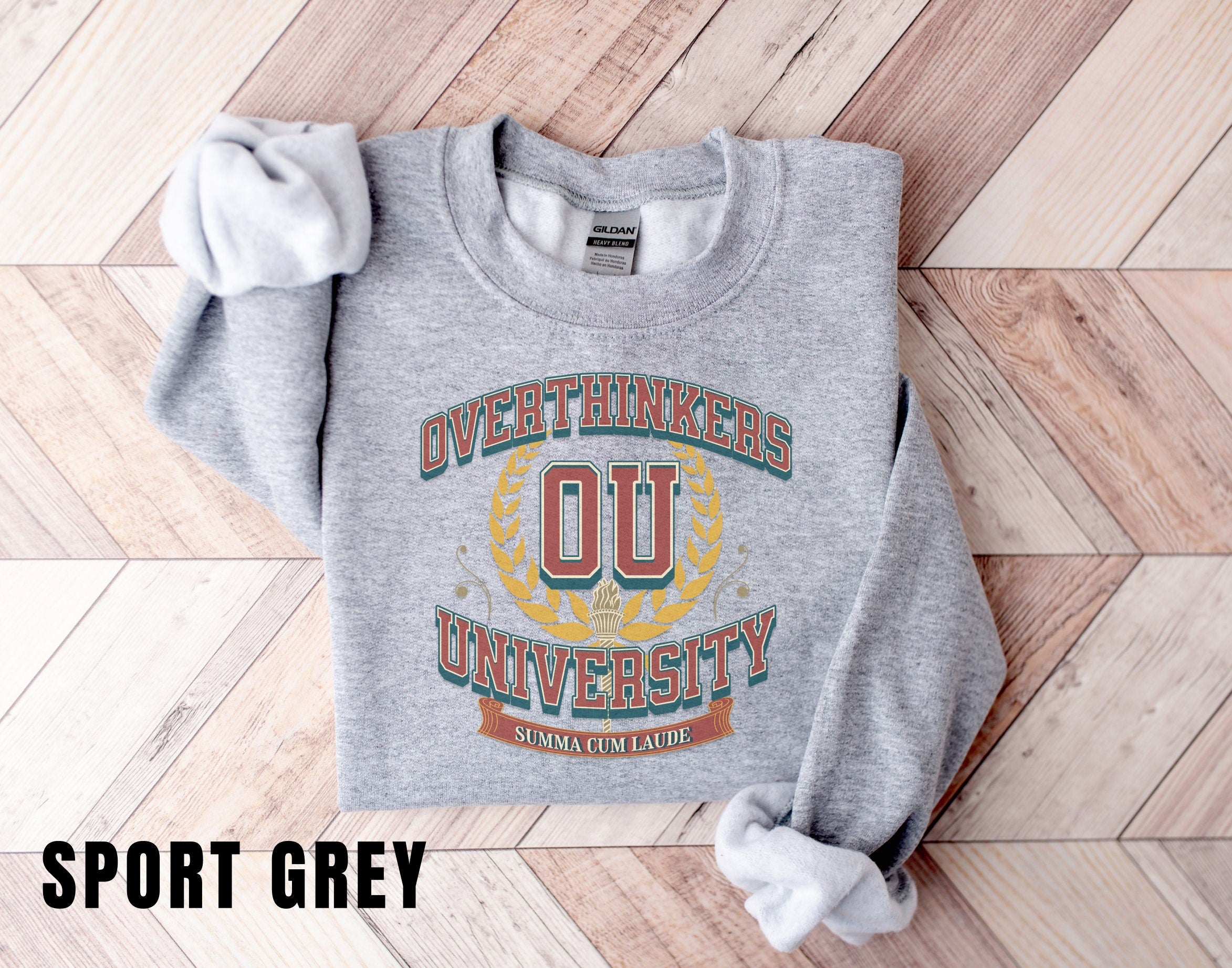 a grey sweatshirt with a university logo on it