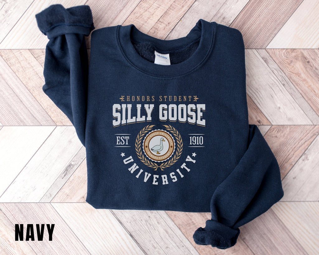 a blue sweatshirt with a seal on it on a wooden floor