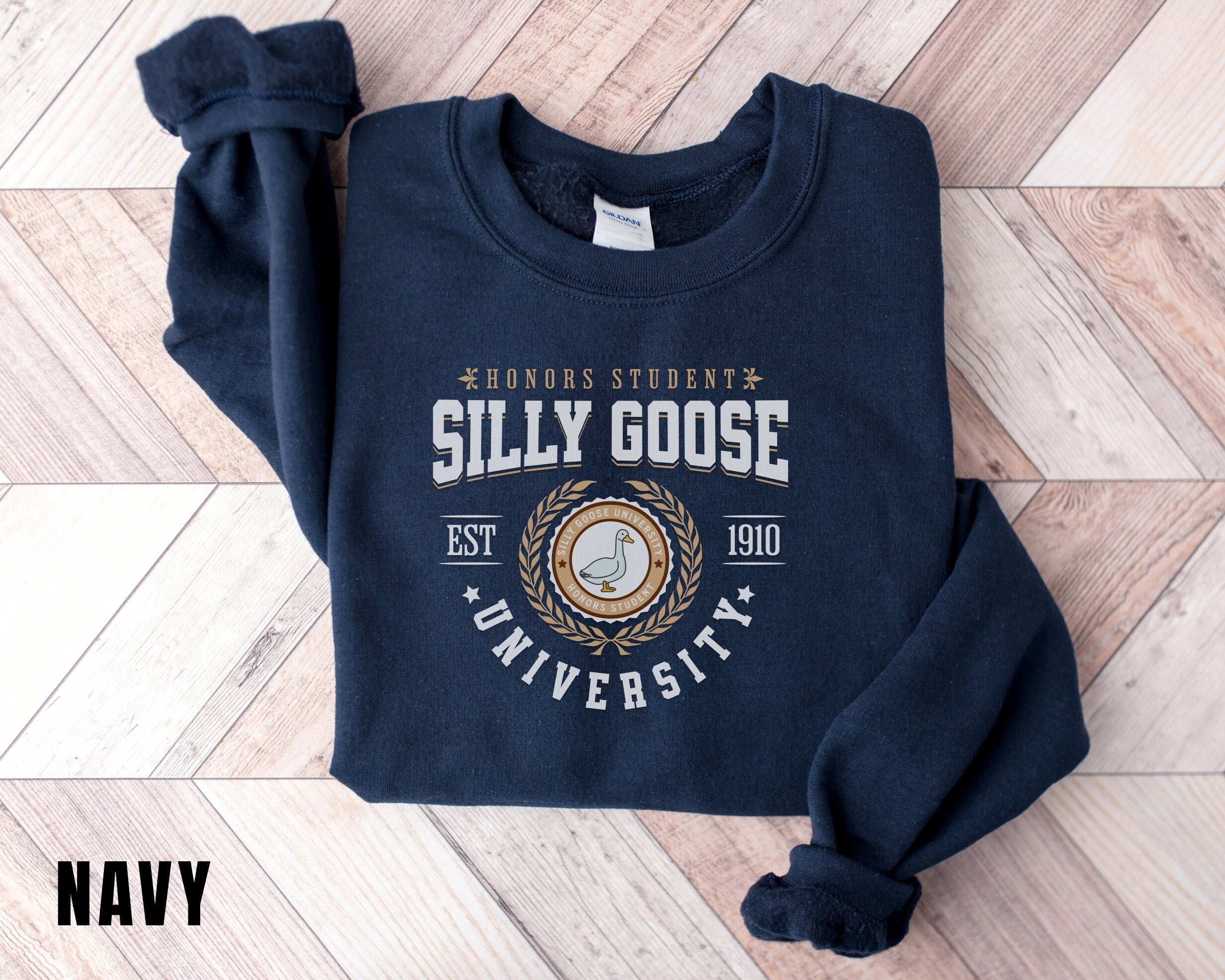 a blue sweatshirt with a seal on it on a wooden floor