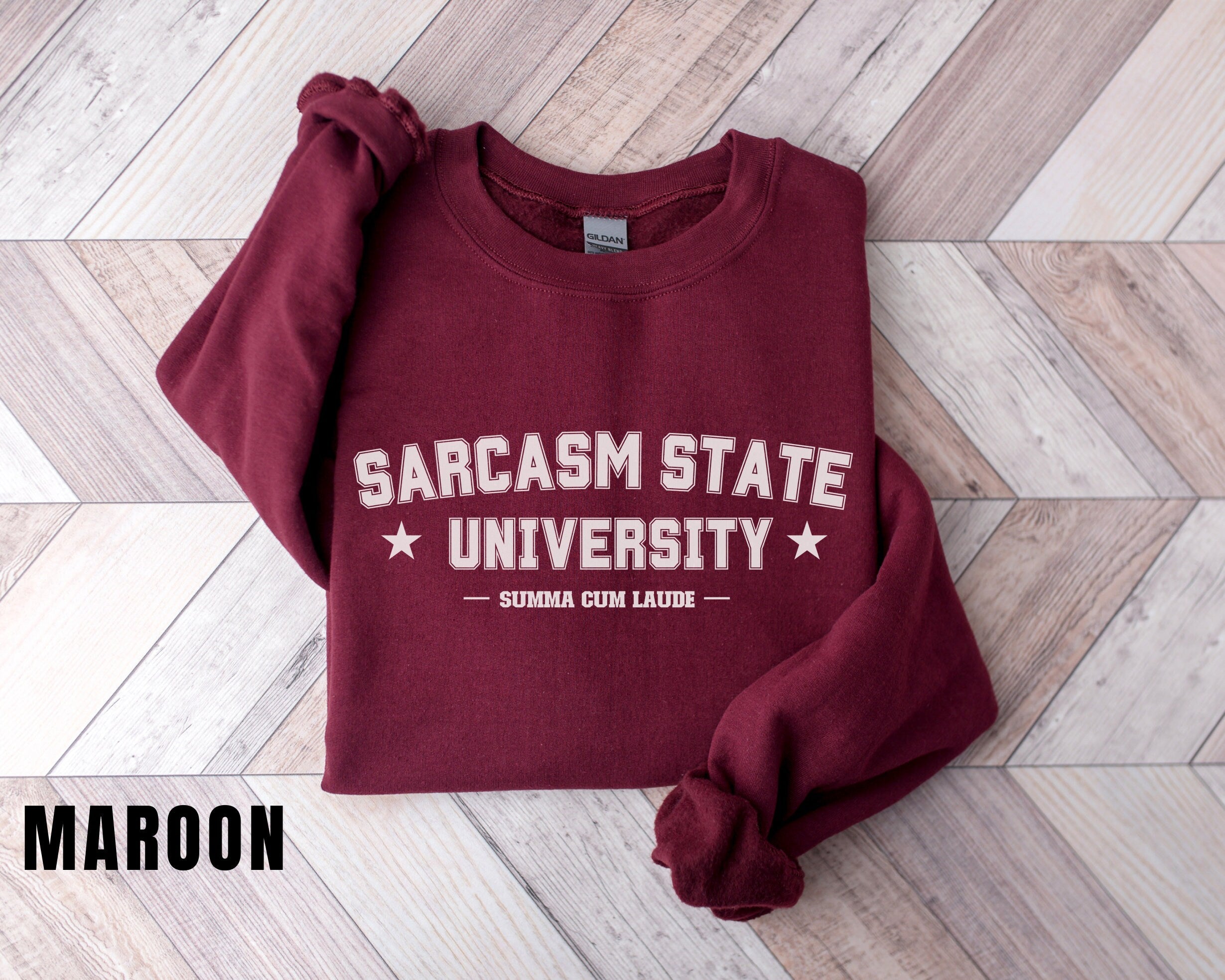 a maroon sweatshirt that says sarcasm state university on it