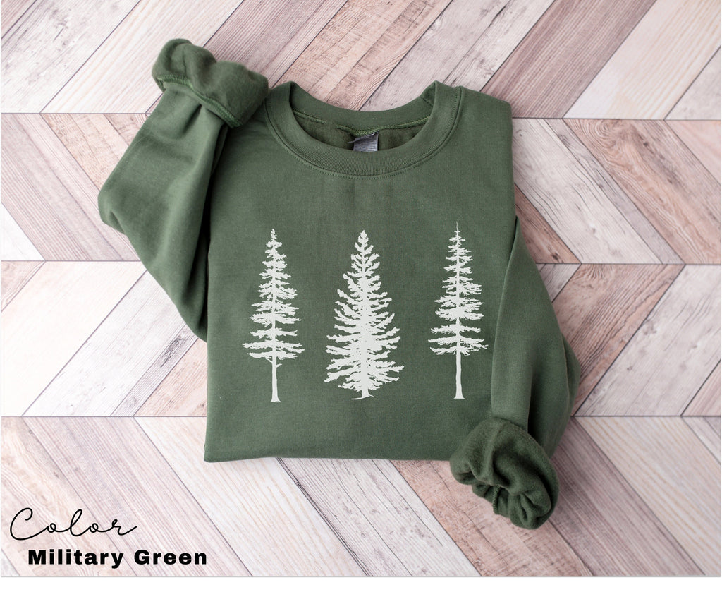 a green shirt with white trees on it