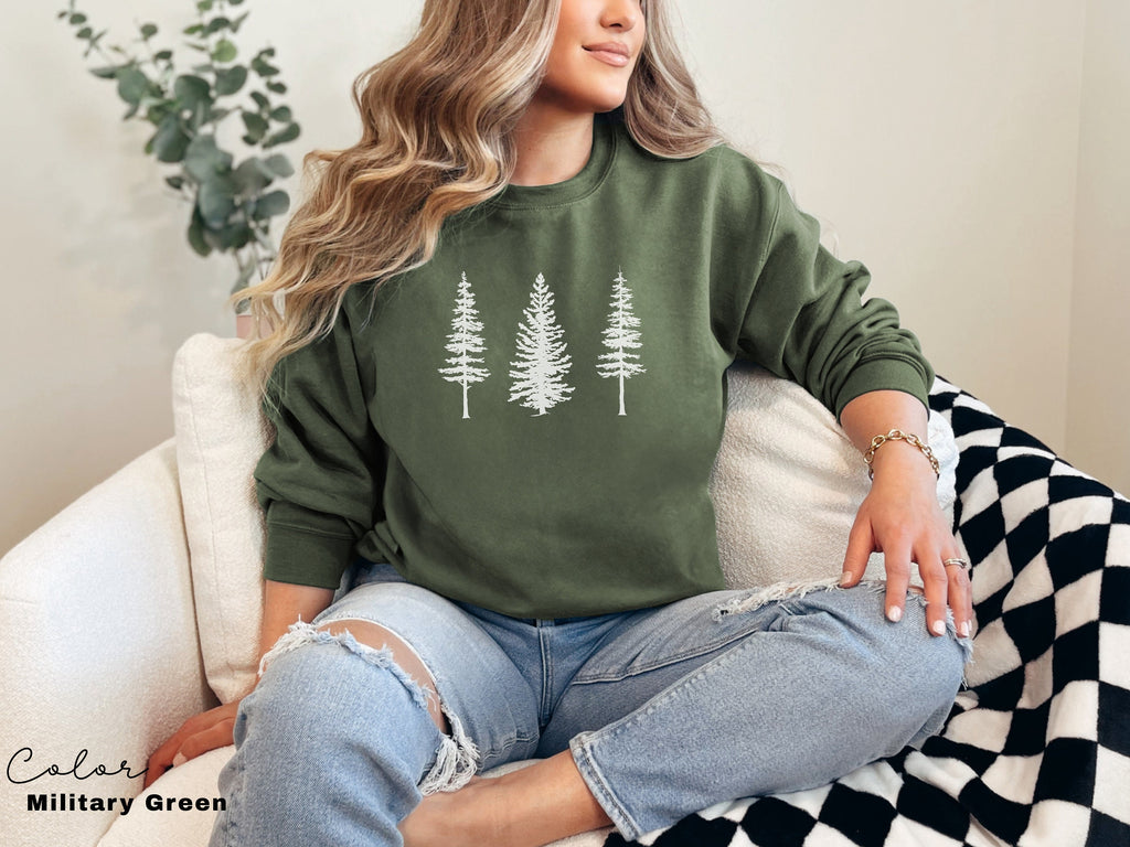 a woman sitting on a couch wearing a green sweatshirt
