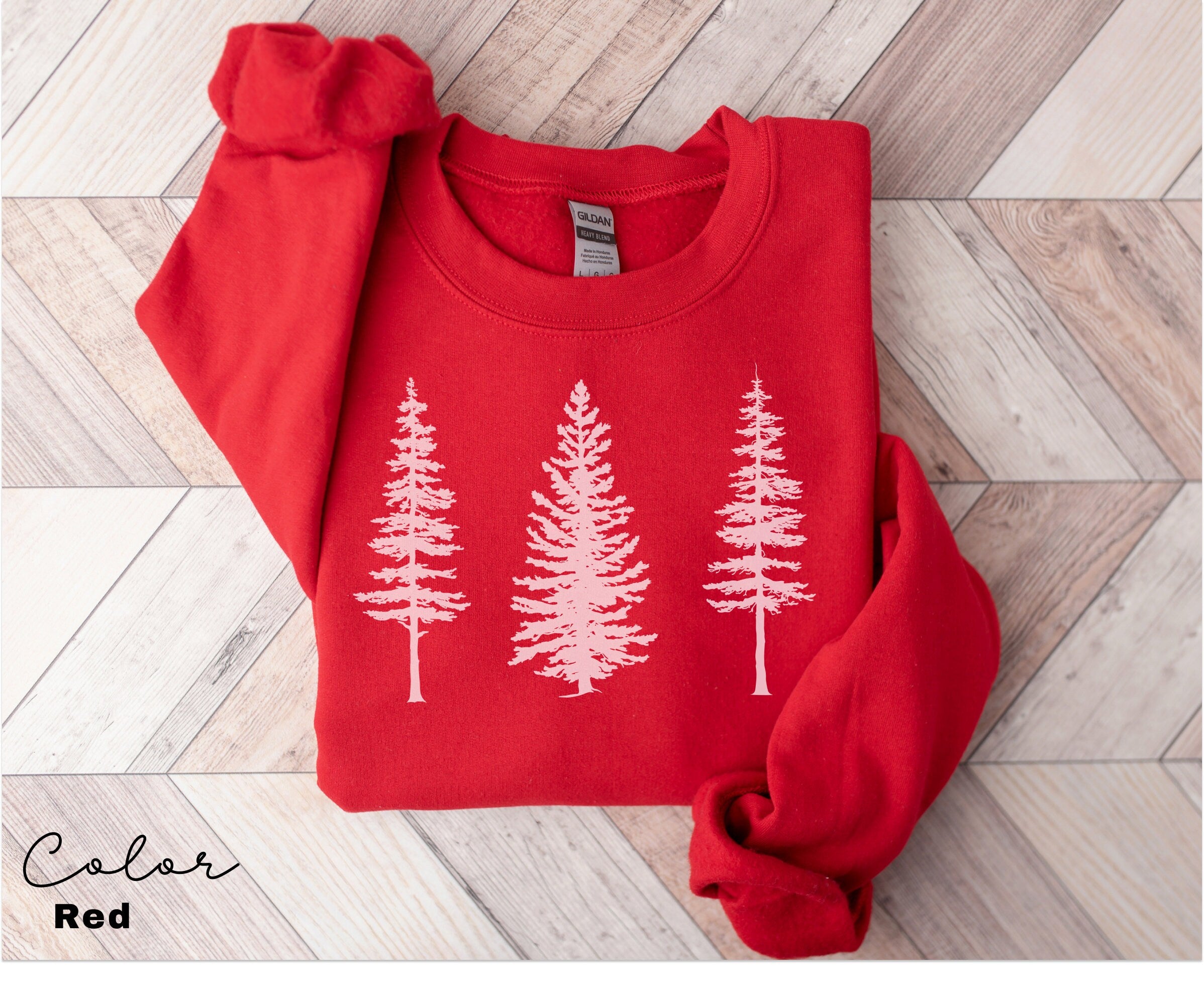 a red sweater with white trees on it