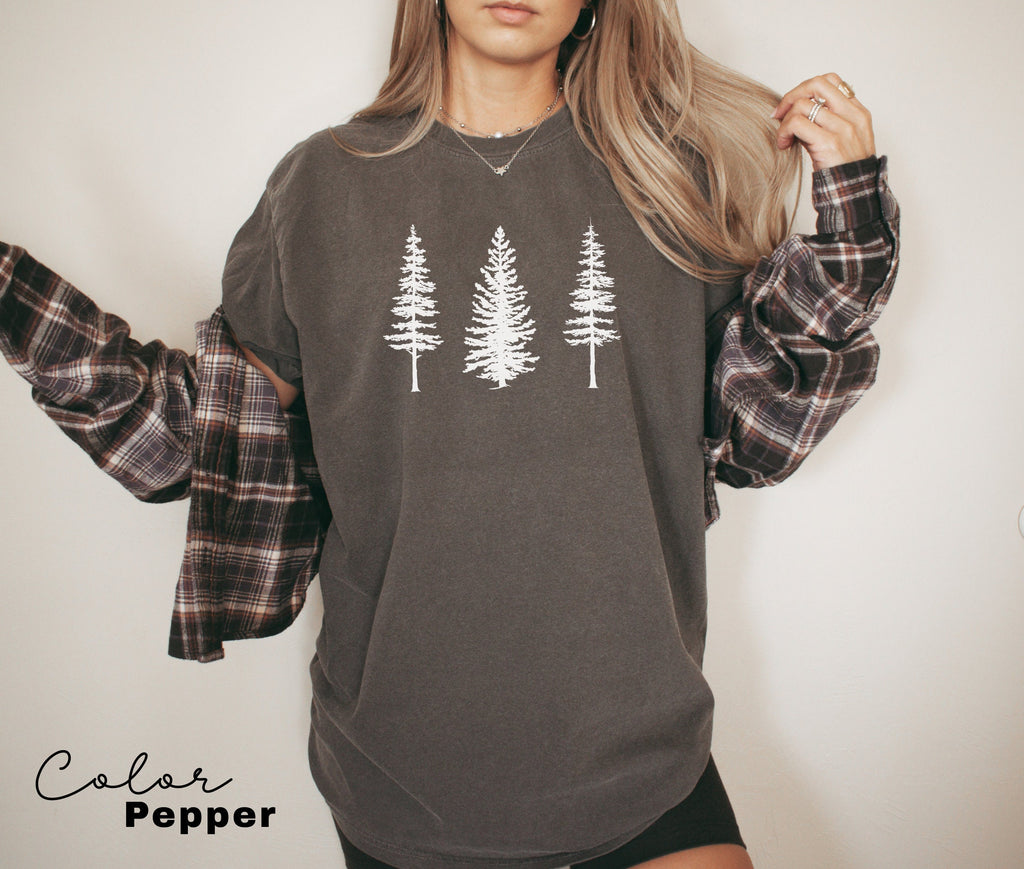a woman wearing a sweatshirt with trees on it