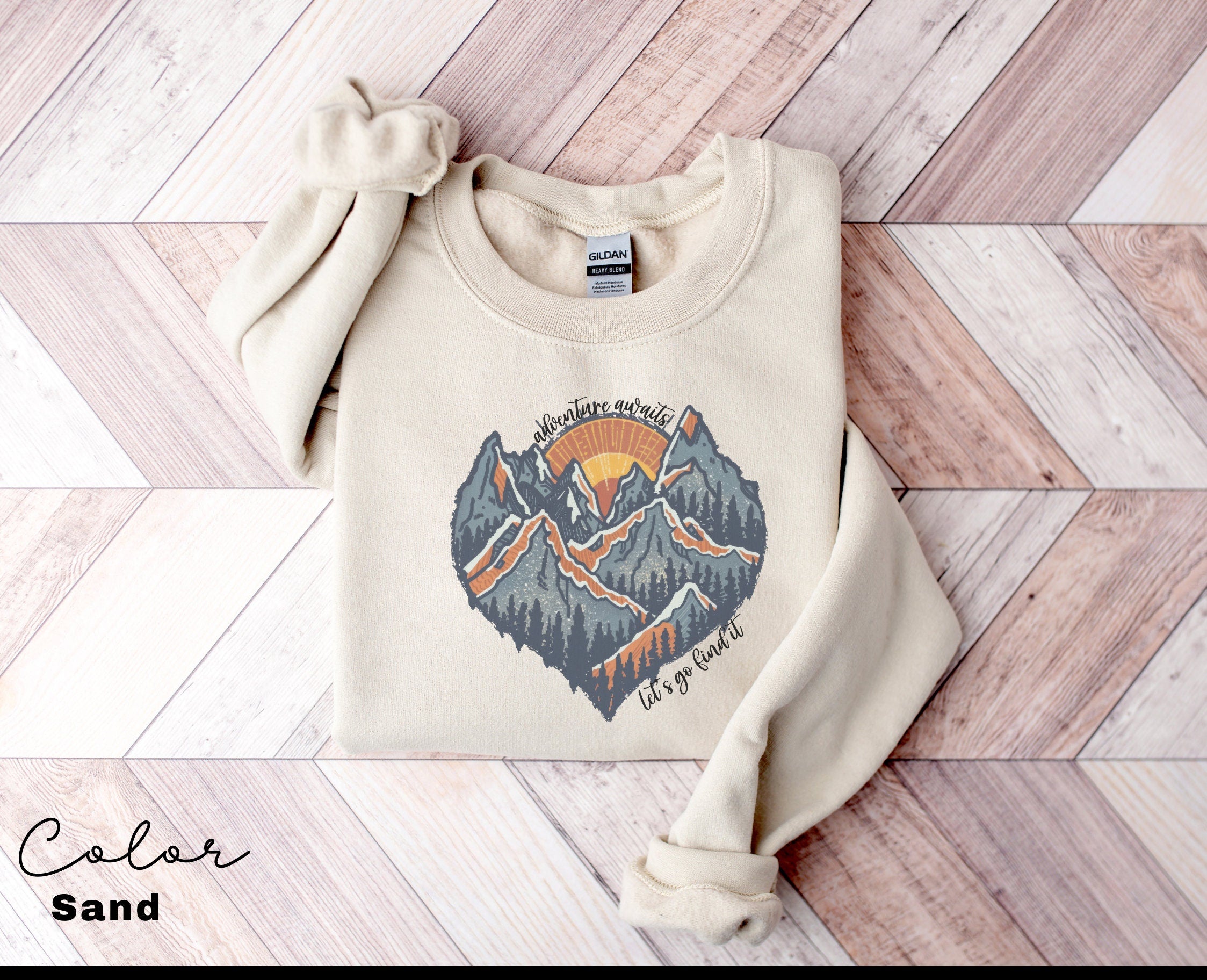 a sweater with a mountain scene on it