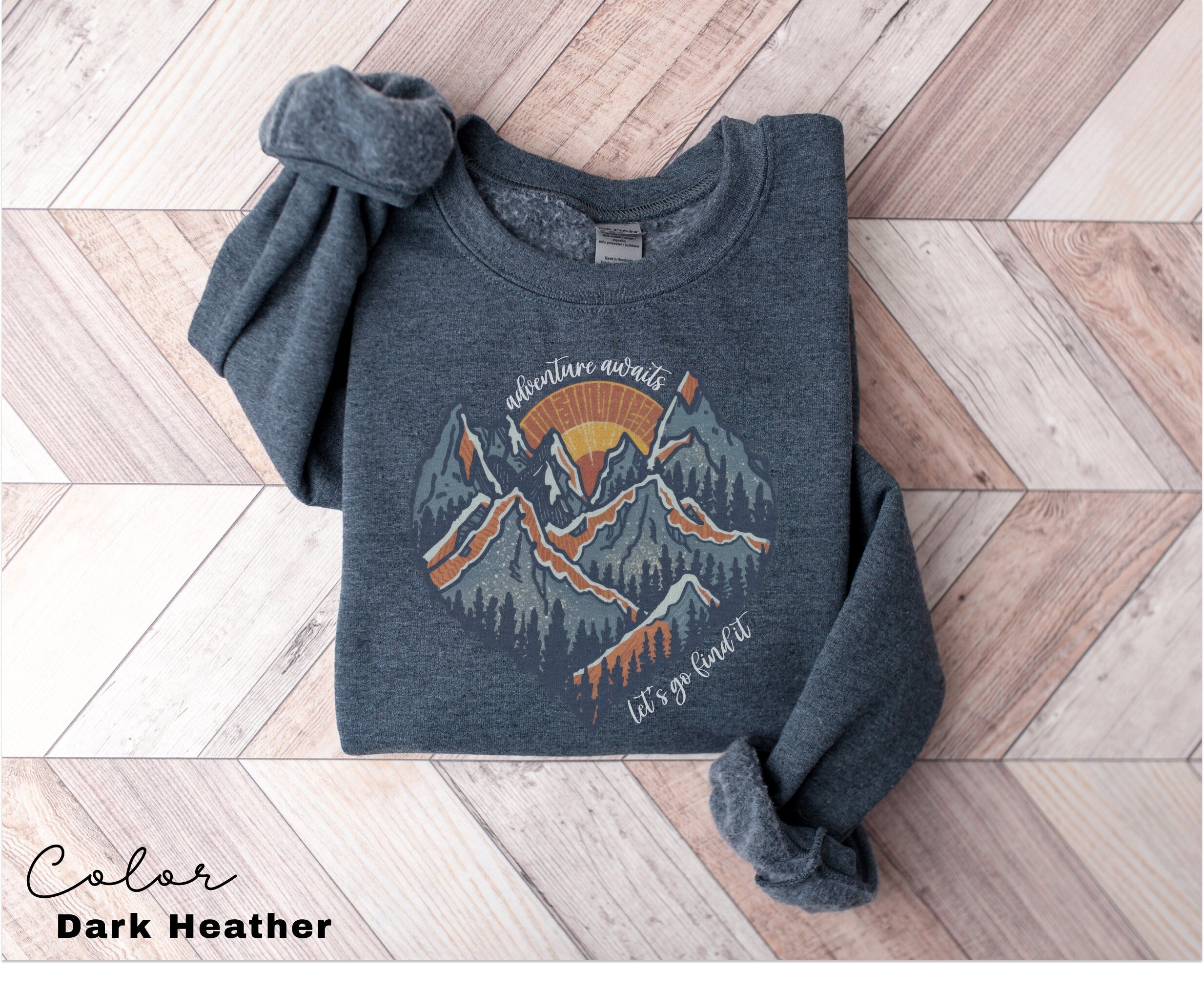 a sweater with a mountain scene on it