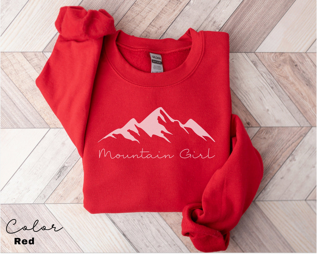 a red sweatshirt with the mountain girl logo on it
