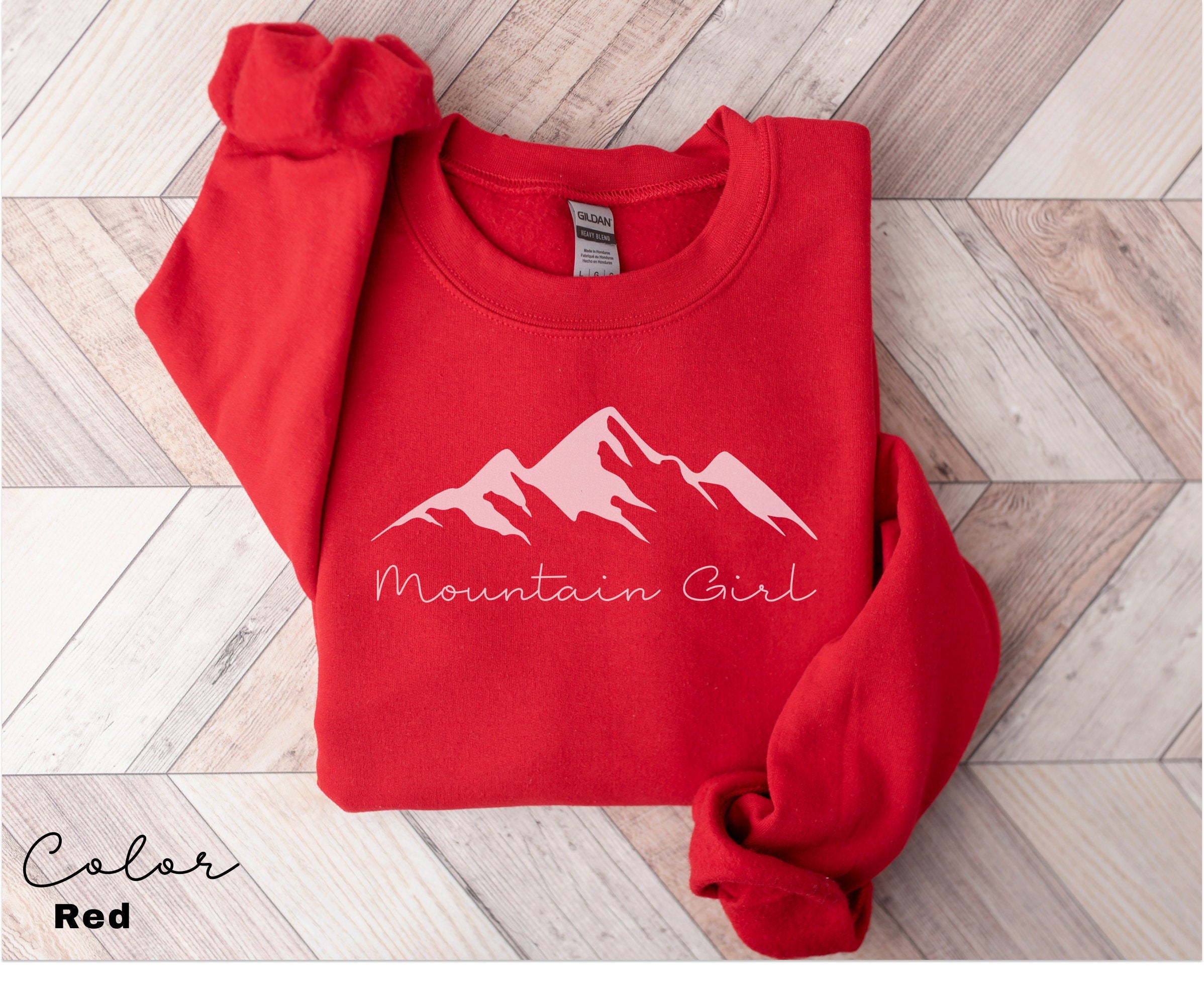 a red sweatshirt with the mountain girl logo on it
