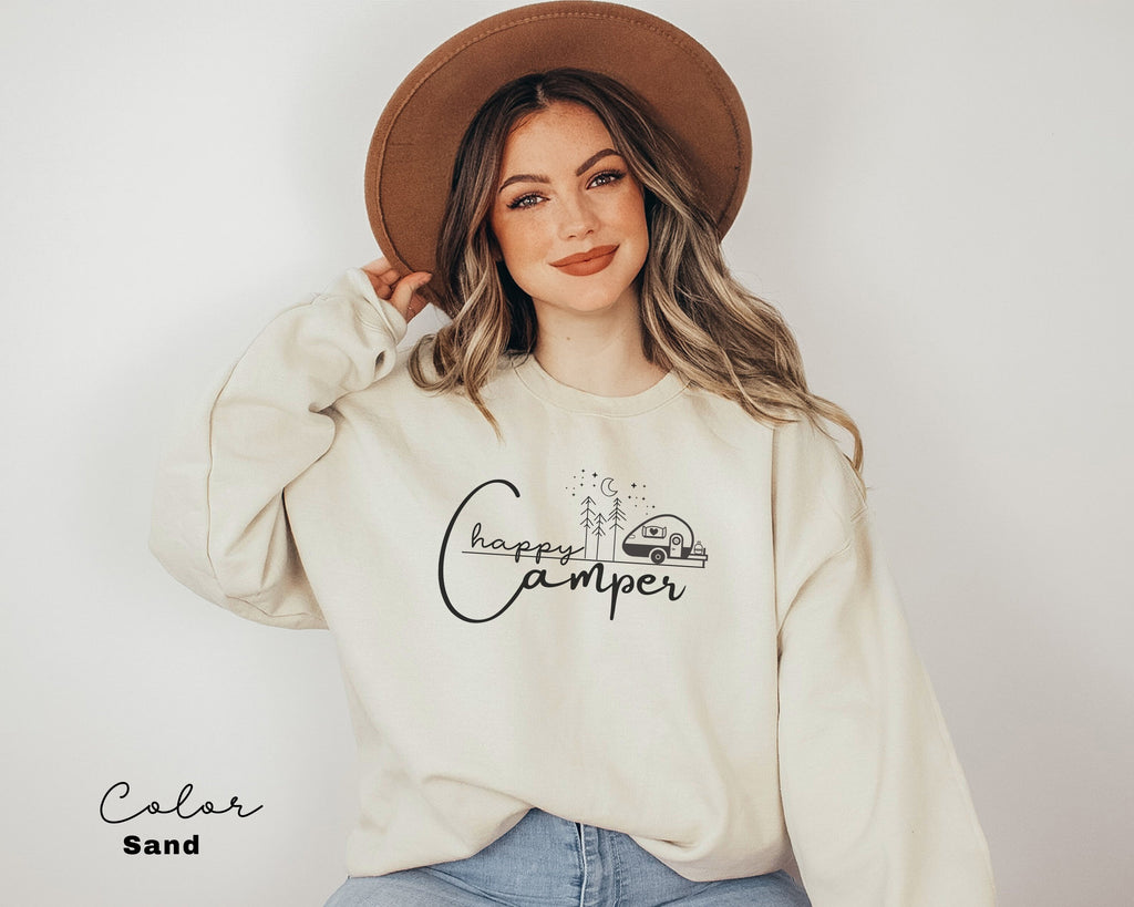 a woman wearing a sweatshirt with a camper on it