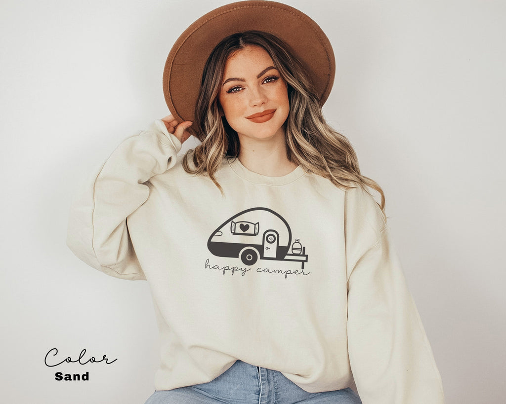 a woman wearing a sweatshirt with a camper on it