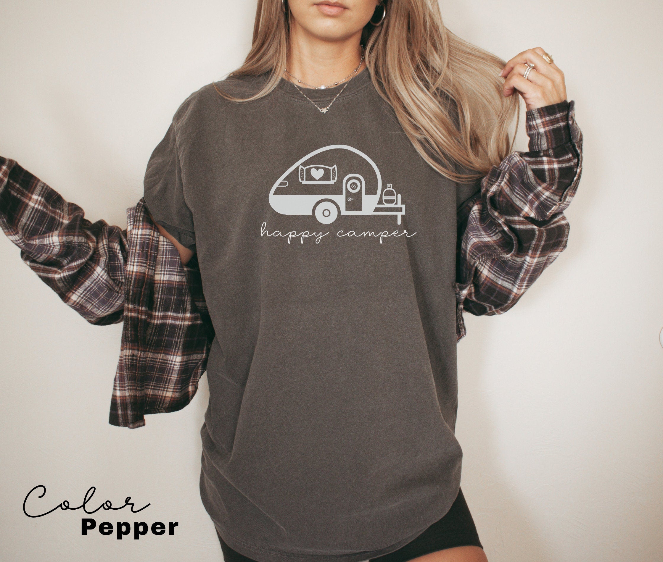 a woman wearing a sweatshirt with a camper on it