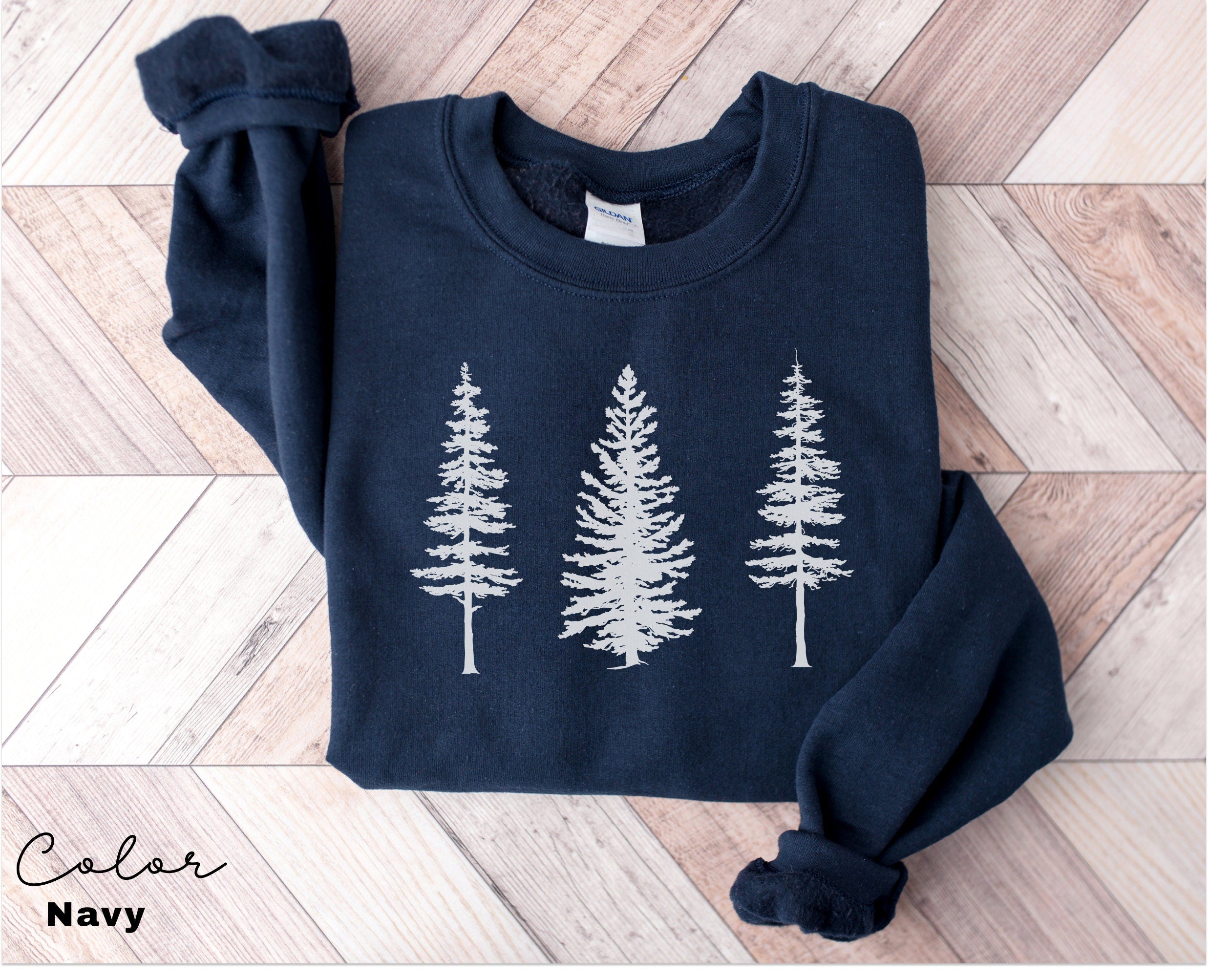 a blue sweater with white trees on it
