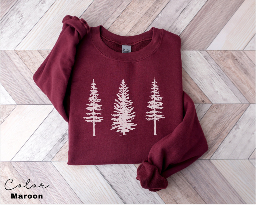 a red sweater with white trees on it