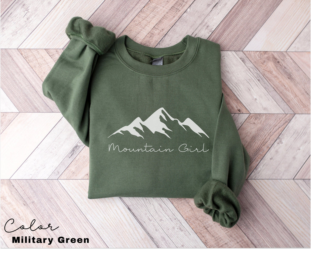 a green shirt with mountains on it that says mountain club