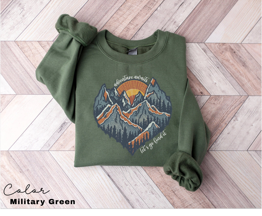 a green sweatshirt with a mountain scene on it