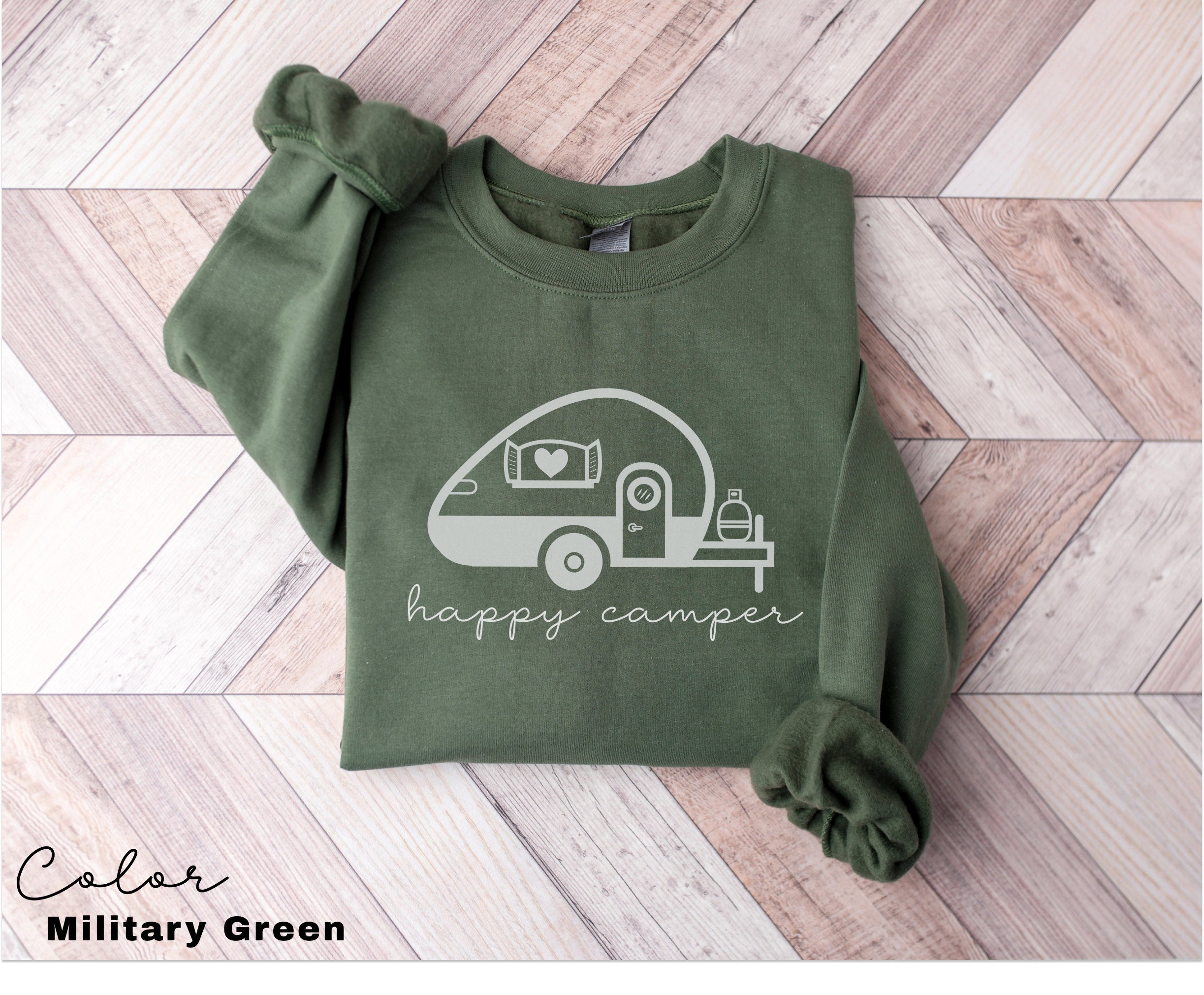 a green shirt with a camper drawn on it