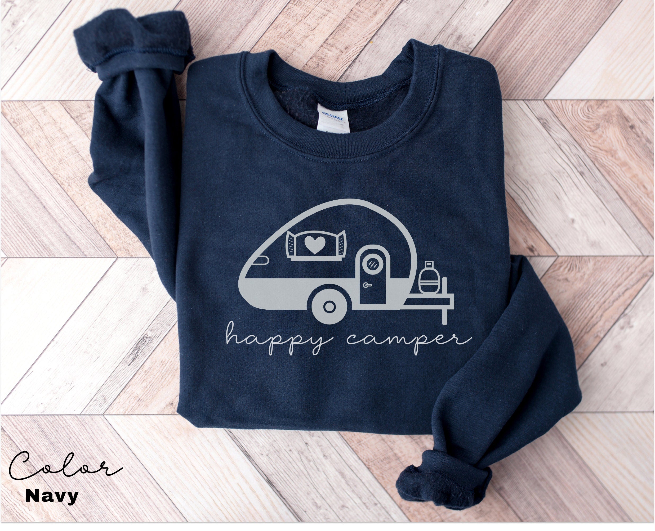 a blue shirt with a camper on it that says happy camper