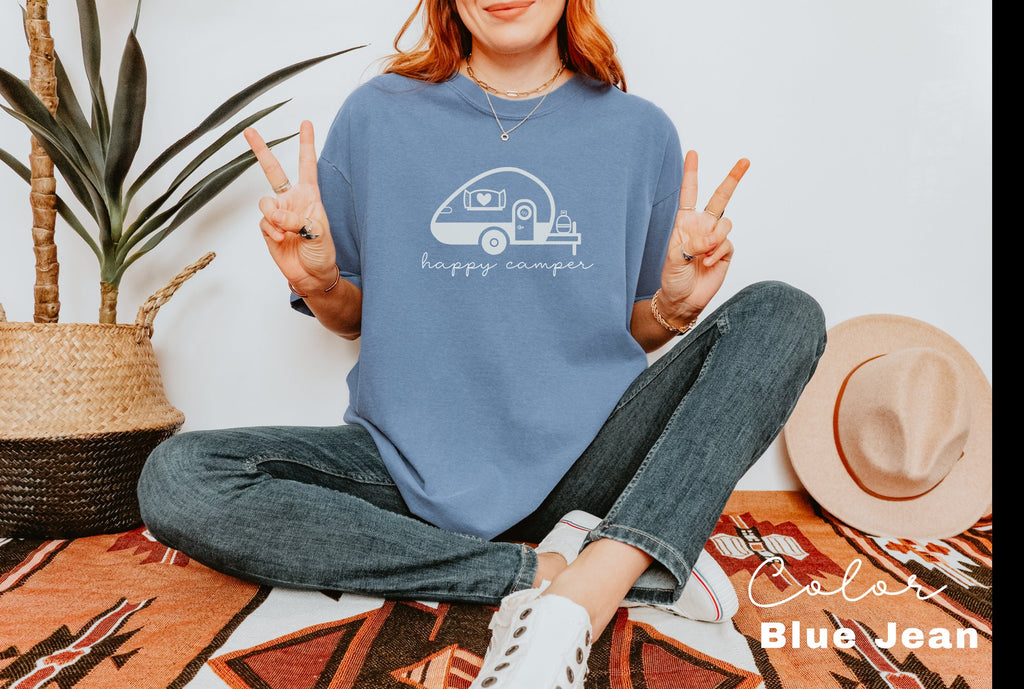 a woman sitting on the floor with her peace sign