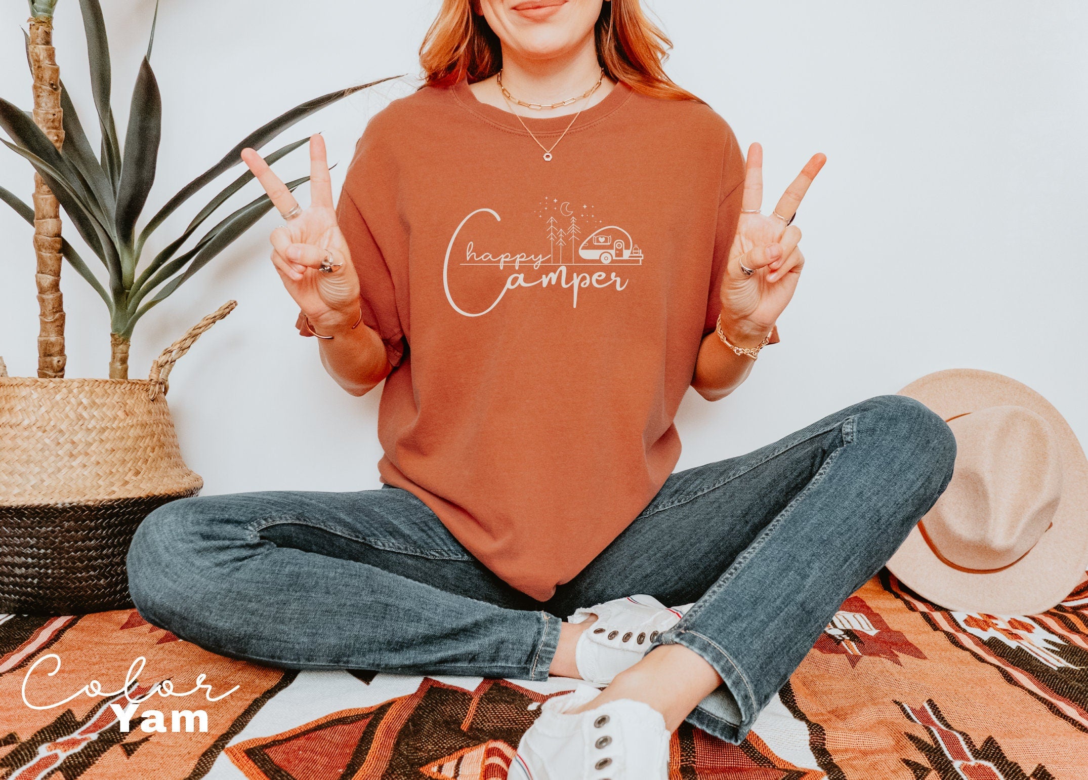 a woman sitting on the floor with a peace sign