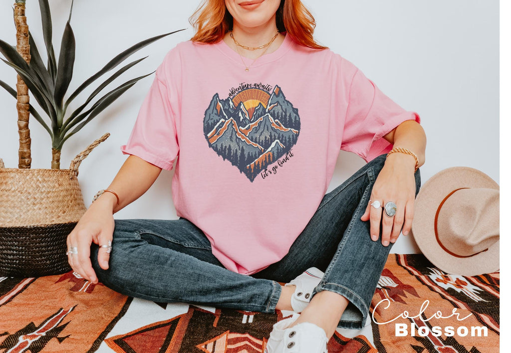 a woman sitting on the floor wearing a pink shirt