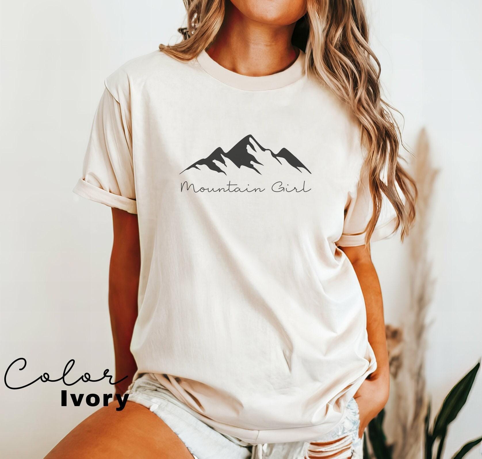 a woman wearing a mountain girl t - shirt