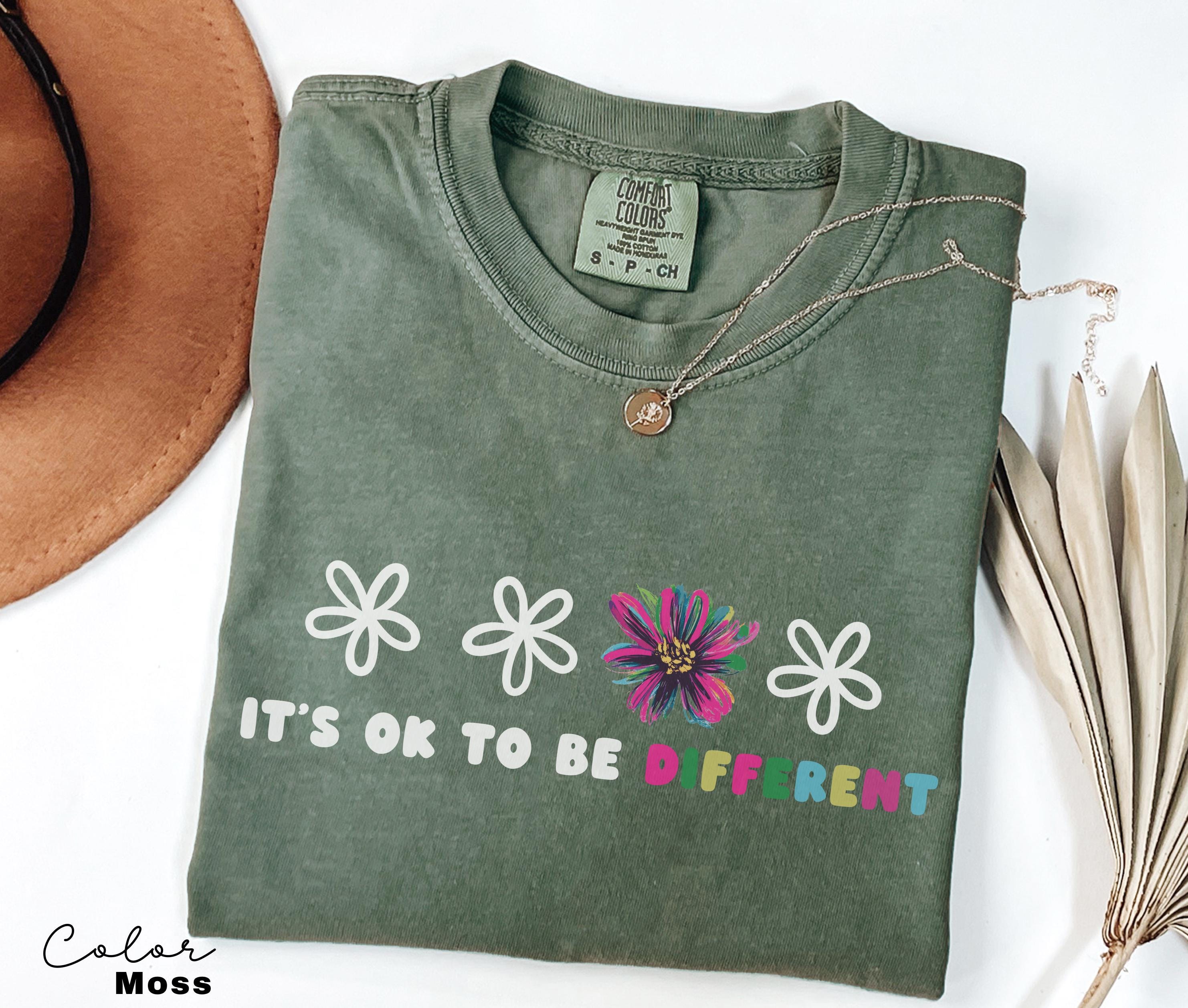 a t - shirt that says it's ok to be off rent next to