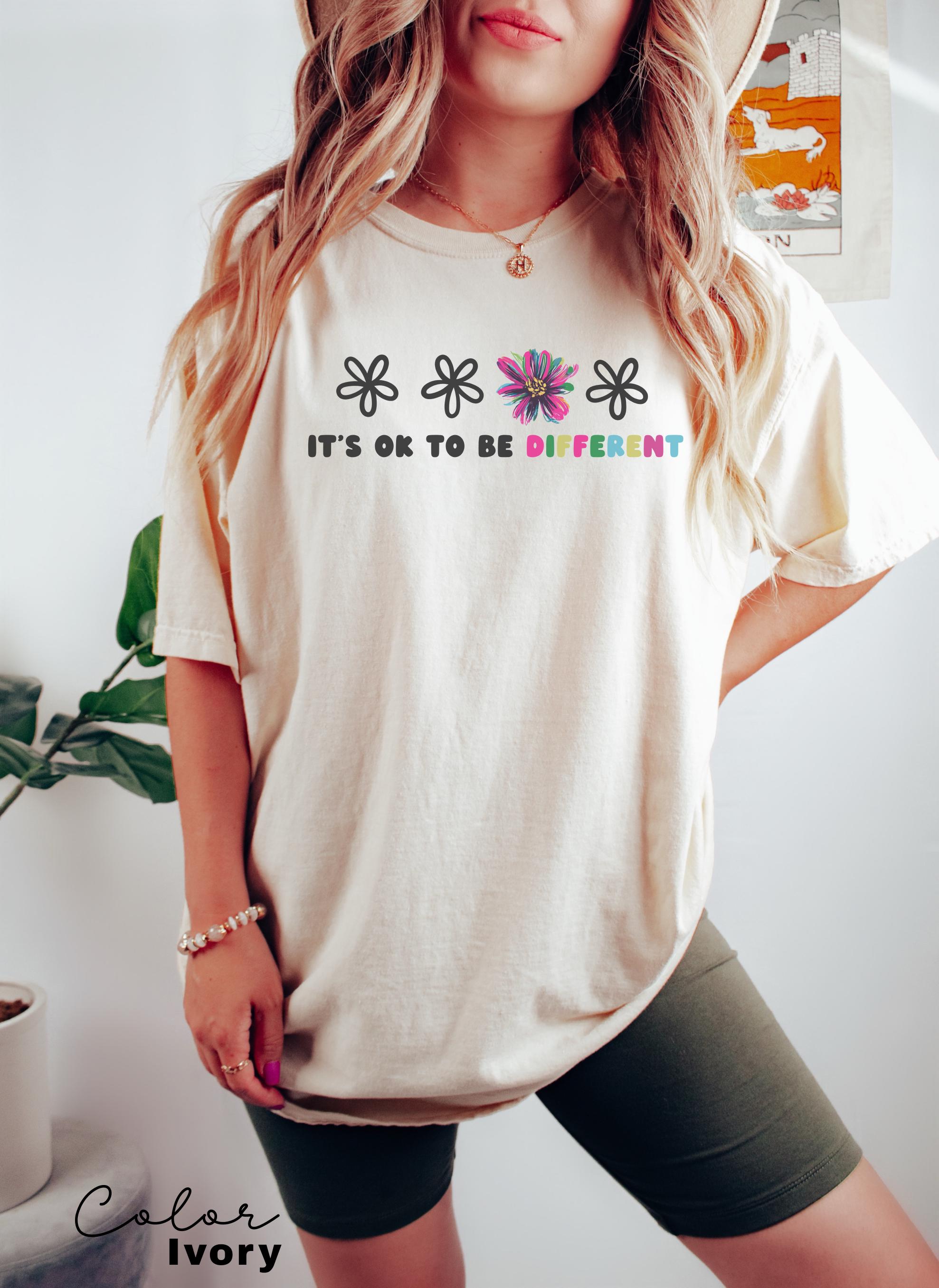 a woman wearing a hat and a t - shirt that says it's ok