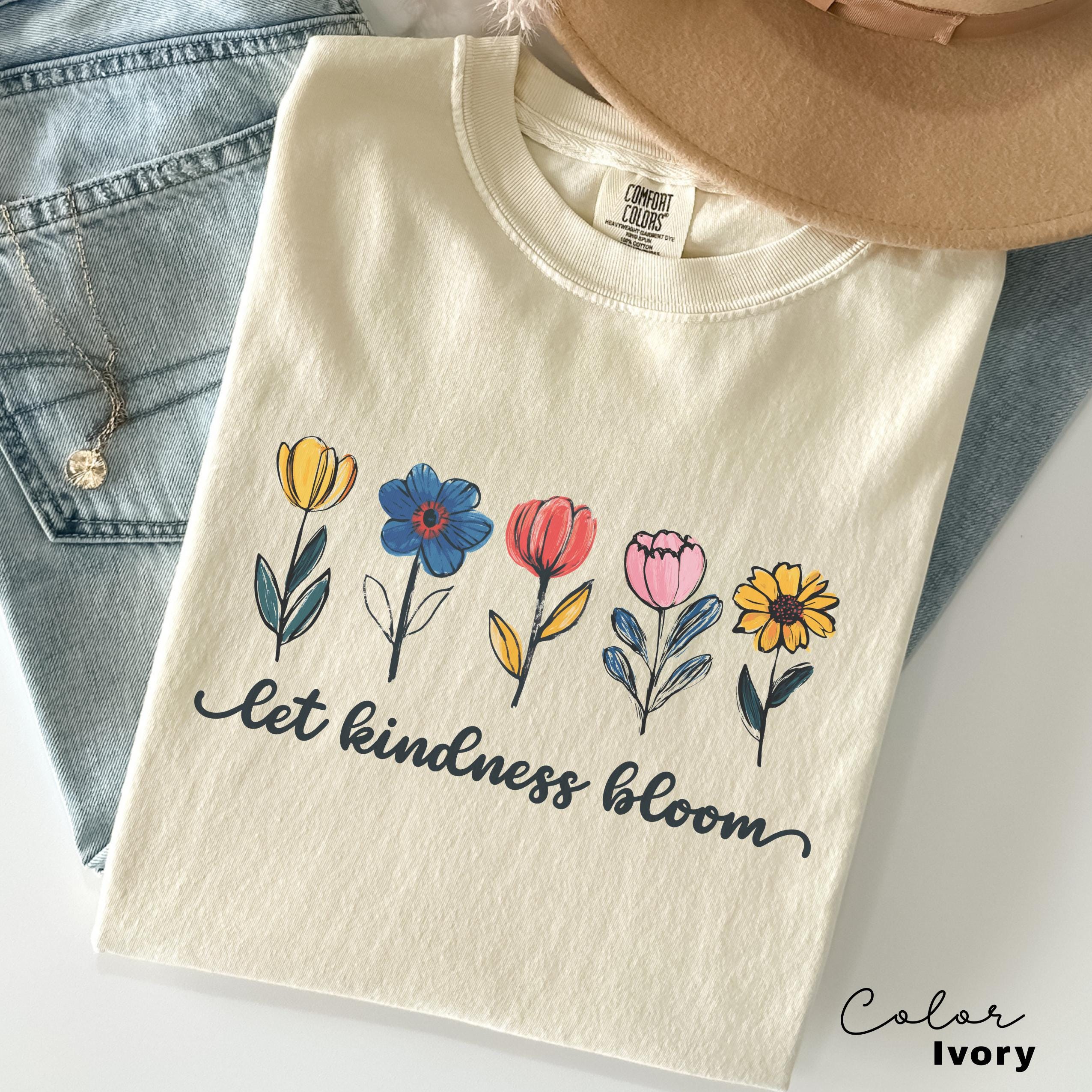 a t - shirt that says let kindness bloom on it