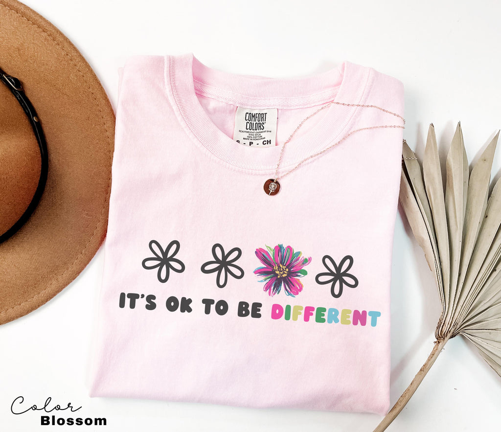 a hat, sunglasses, and a t - shirt on a table