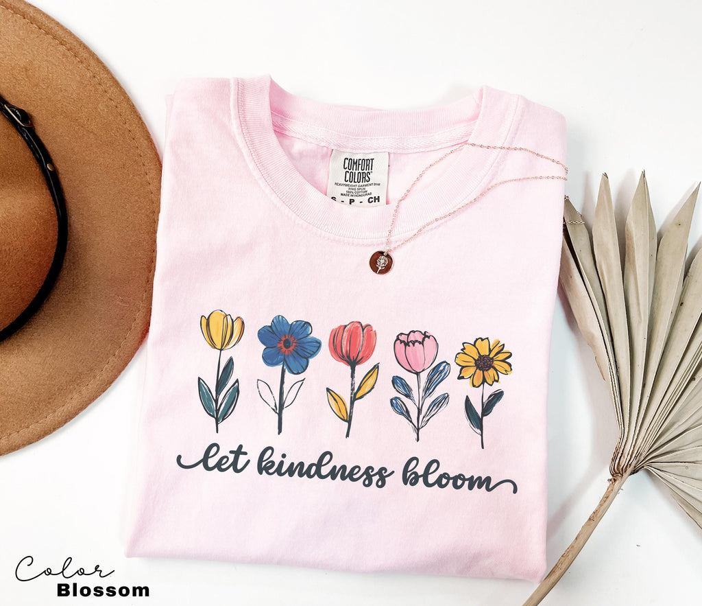 a hat, sunglasses, and a t - shirt on a table