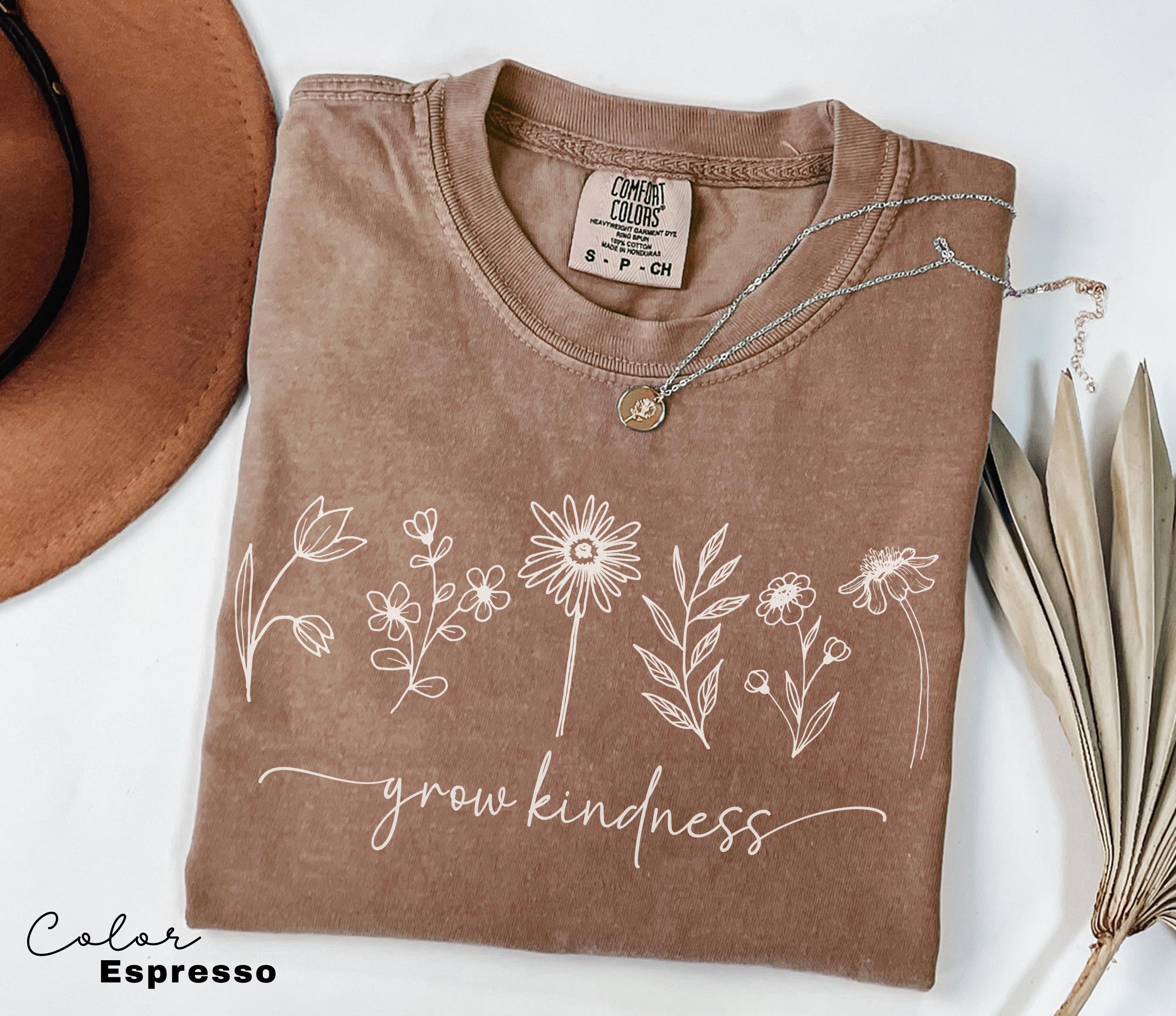 a brown t - shirt with a picture of flowers on it
