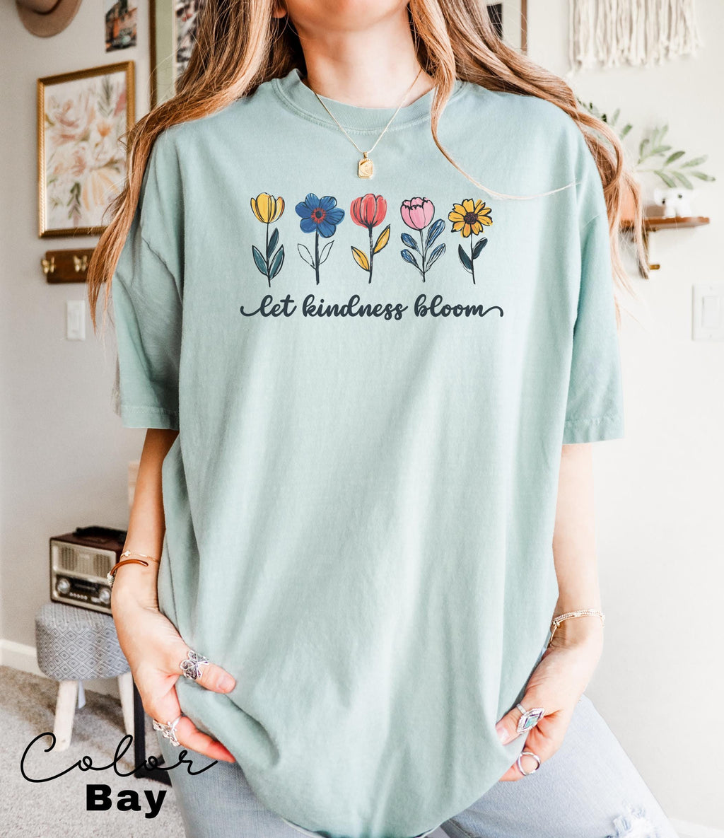 a woman wearing a t - shirt with flowers on it