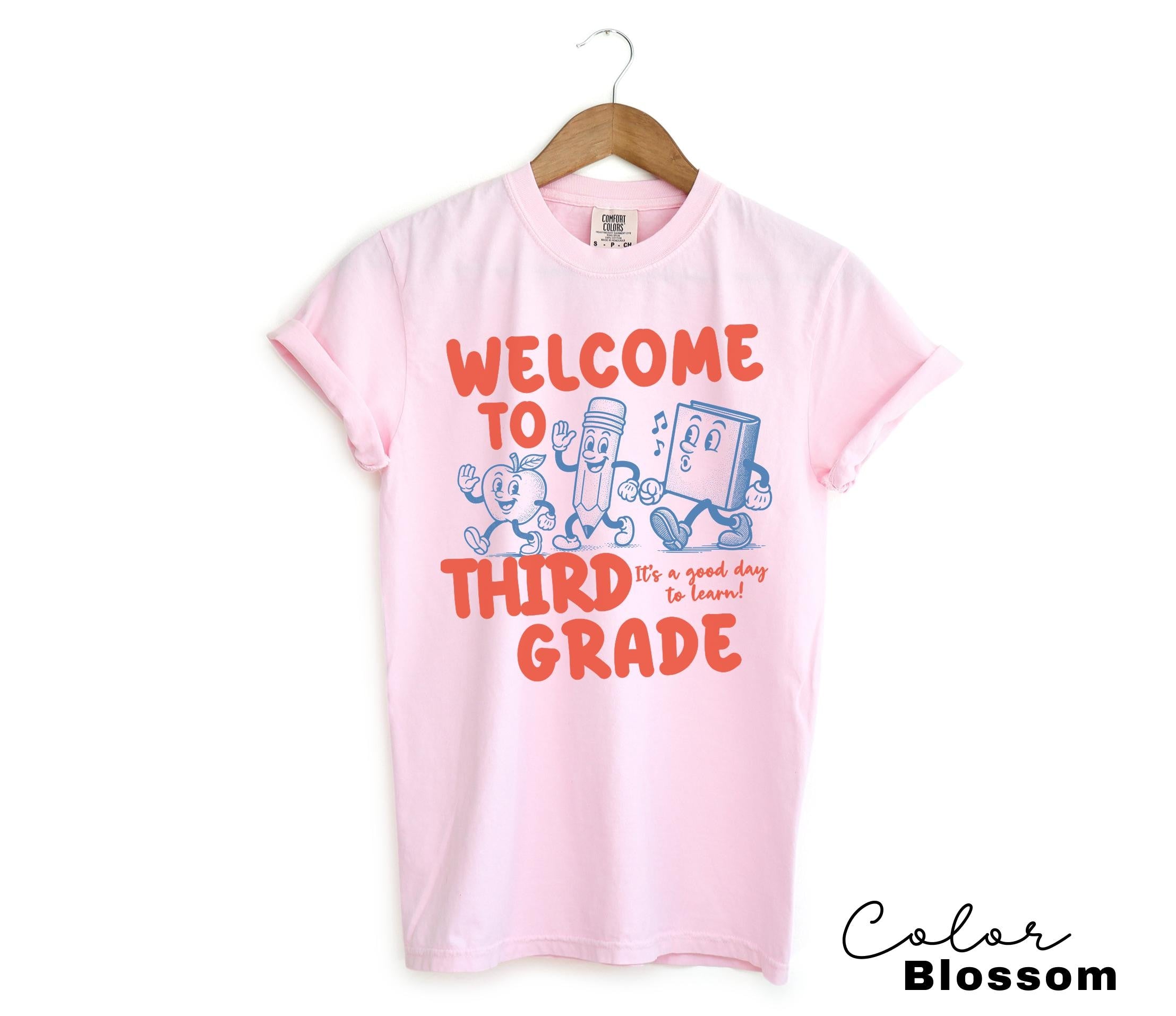 a pink shirt that says welcome to third grade