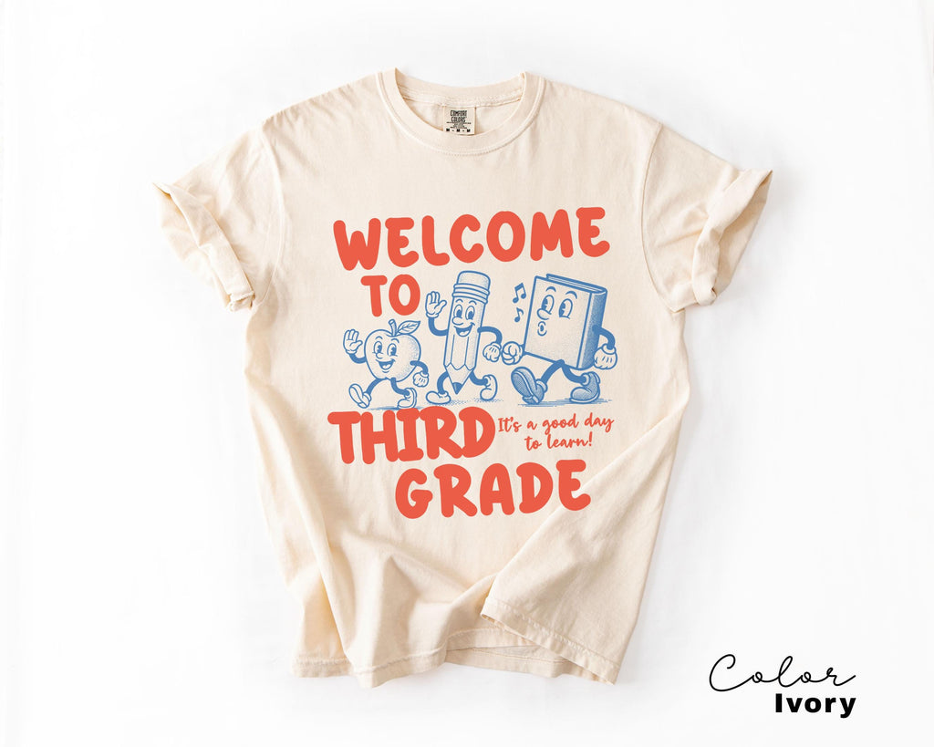 a t - shirt that says, welcome to third grade