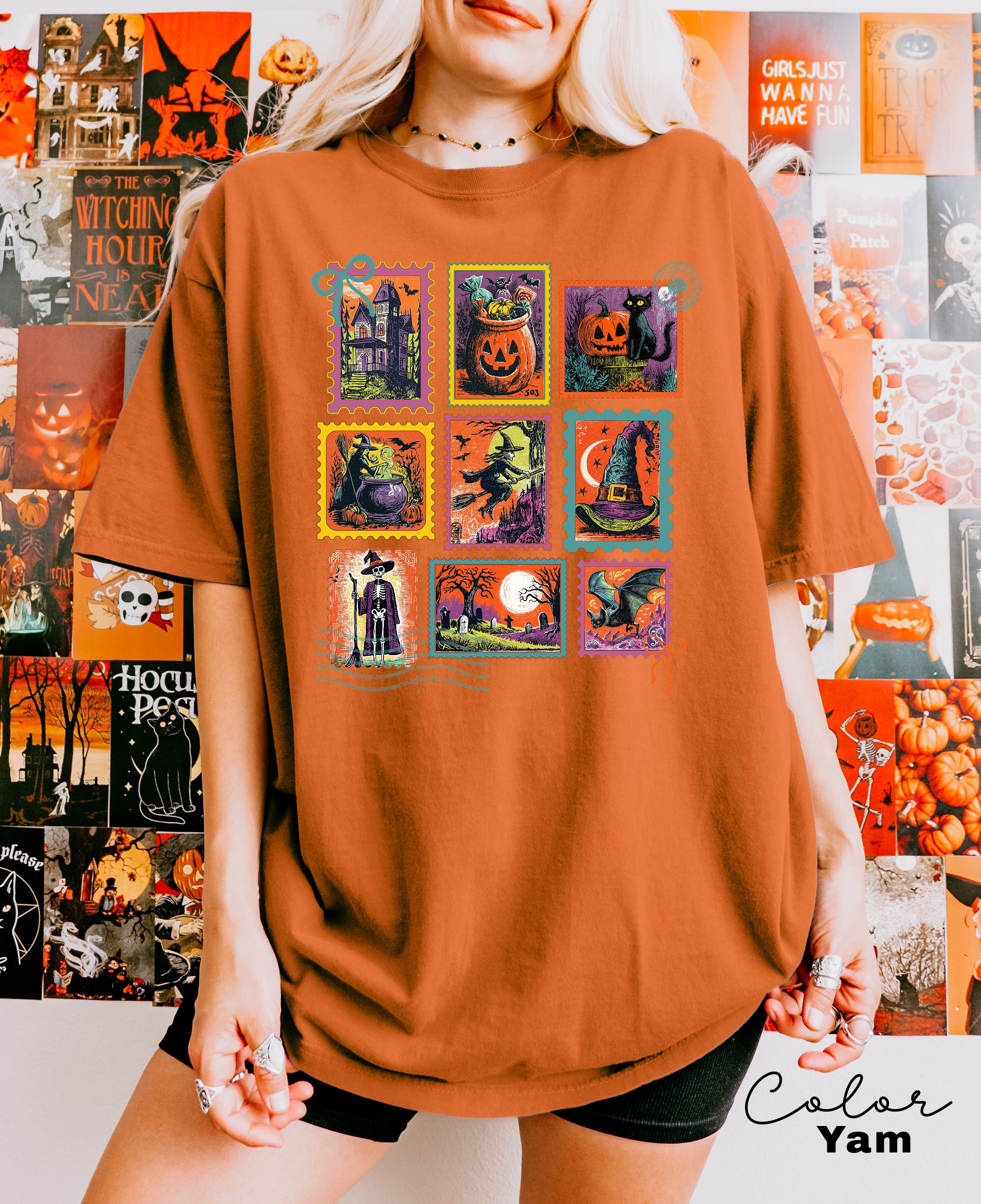 A person wearing a t-shirt with a collage of Halloween-themed illustrations, including pumpkins, bats, and other spooky elements.