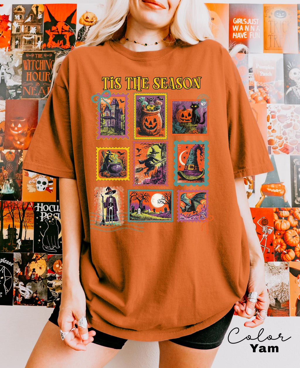 A person wearing a t-shirt with a collage of Halloween-themed illustrations, including pumpkins, bats, and other spooky and festive elements.