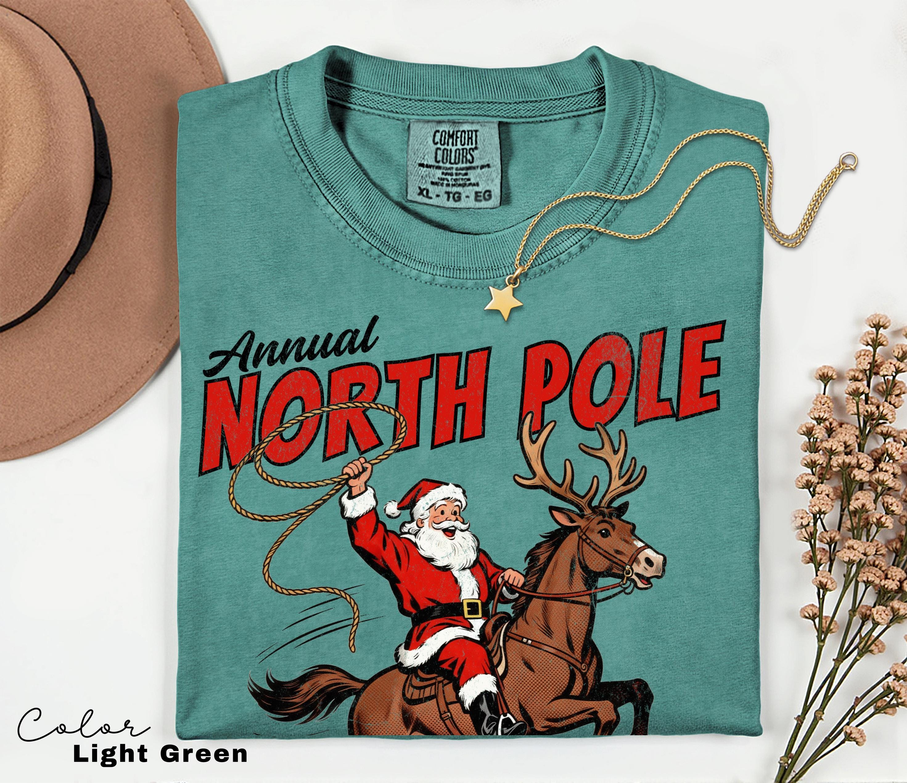 Retro Christmas North Pole Rodeo Shirt, Cowboy Santa Western Roping Christmas Shirt, Howdy Christmas T-shirt, Cowgirl Gift Wrangling Santa